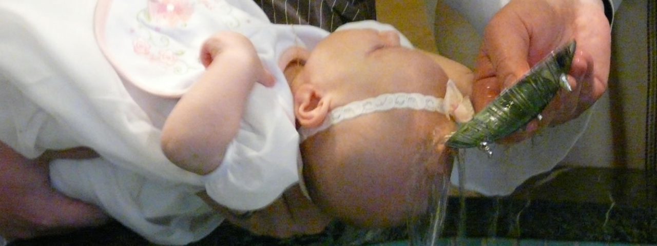 Slideshow image of an infant being baptized.